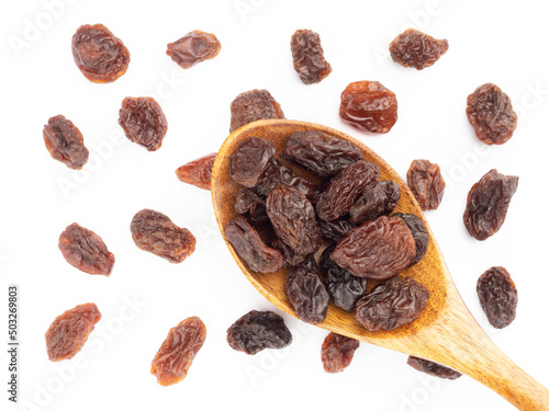 Raisin in spoon and bunch isolated on white background. Macro. Vegetarian concept