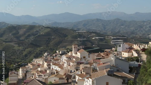 Iznate village between mountains at sunset, Axarquia, Malaga, Spain photo