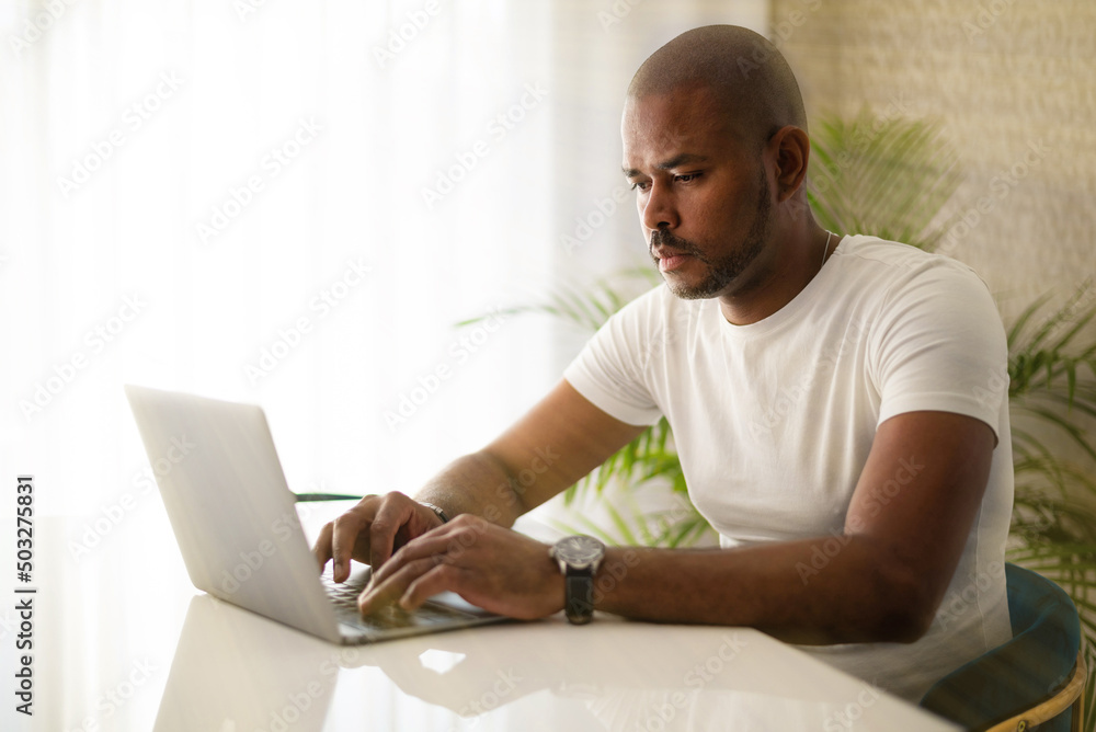 A black man works at a computer. Doing business. A black man works at a computer. Doing business.