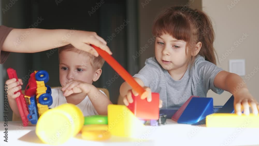 kindergarten. a group of children lifestyle play toys cubes and cars on the table in kindergarten. kid dream creative happy family preschool education concept. nursery baby toddler home kindergarten. a group of children lifestyle play toys cubes and cars on the table in kindergarten. kid dream creative happy family preschool education concept. nursery baby toddler home