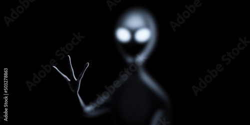 Fotografía Alien stretches his hand on the dark
