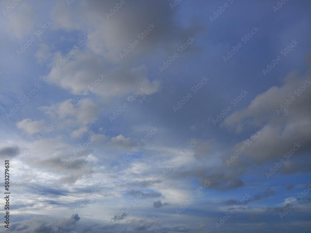 gray stratocumulus cloud and blue sky