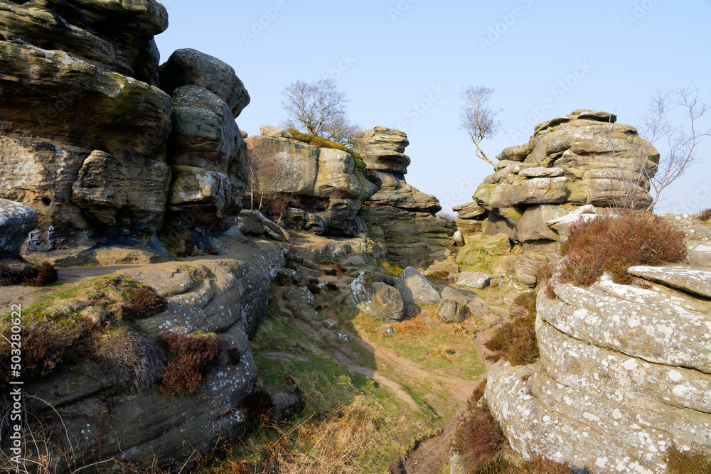 Narrow path between weathered gritstone rocks