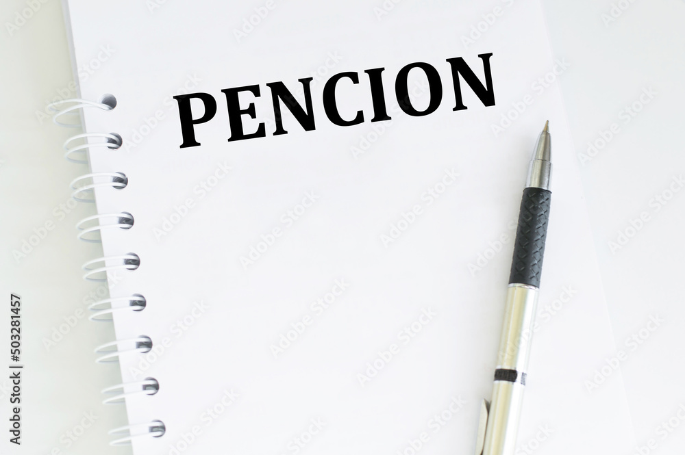 PENCION text on text in notepad on a light table PENCION text on text in notepad on a light table