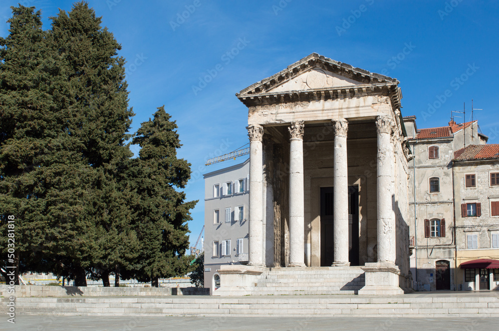 Roman temple of Augustus with Corinthian columns, well preserved ancient architecture on a city square, in Pula, Croatia