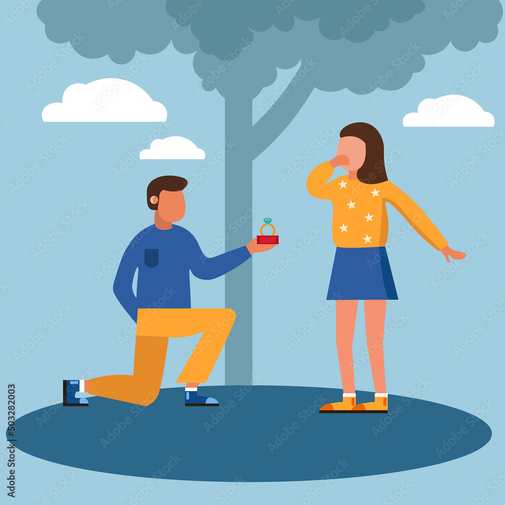 a guy in yellow jeans and a blue sweater on his knees makes a marriage proposal to a girl in a blue skirt and a yellow sweater against the backdrop of a large tree and clouds