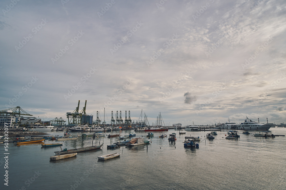 View of boats in the sea, with oil platforms in the background in singapore