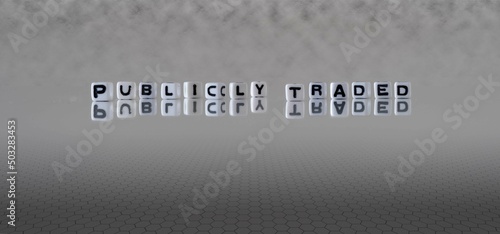 publicly traded word or concept represented by black and white letter cubes on a grey horizon background stretching to infinity