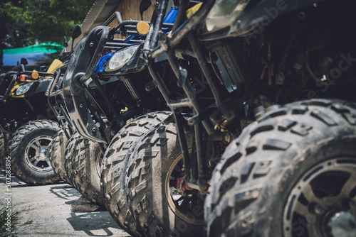 View of row dirty ATVs quad bike