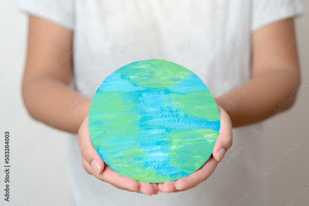 Woman hands holding paper colored earth element to empowered saving the world concept. Love and care to the earth. Woman hands holding paper colored earth element to empowered saving the world concept. Love and care to the earth.