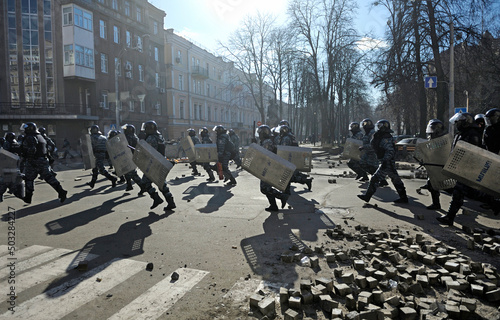 Policemen Berkut unit attacking protesters on Institutskaya street. Revolution of Dignity, the first street clashes. Kiev, Ukraine photo