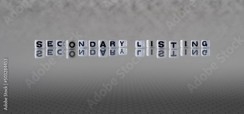 secondary listing word or concept represented by black and white letter cubes on a grey horizon background stretching to infinity