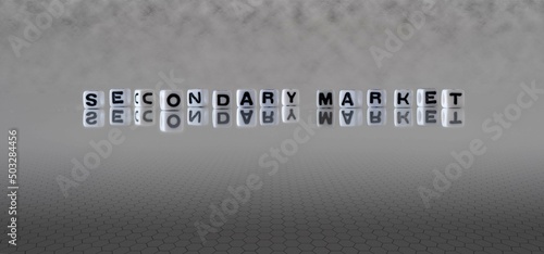 secondary market word or concept represented by black and white letter cubes on a grey horizon background stretching to infinity