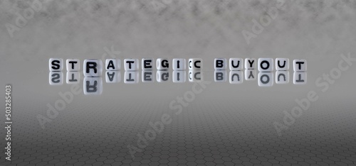 strategic buyout word or concept represented by black and white letter cubes on a grey horizon background stretching to infinity