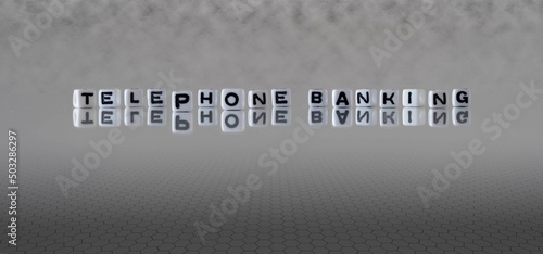 telephone banking word or concept represented by black and white letter cubes on a grey horizon background stretching to infinity
