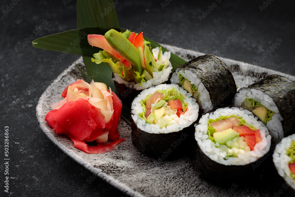 Sushi roll Yasai on a dark plate Sushi roll Yasai on a dark plate