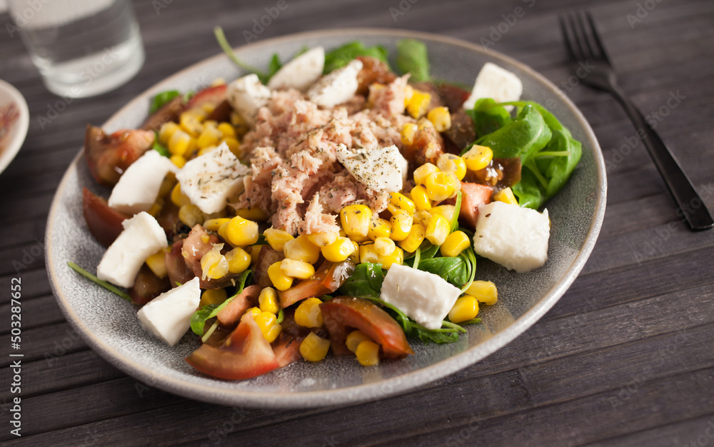 Fish salad with canned tuna and corn, tomatoes and arugula Fish salad with canned tuna and corn, tomatoes and arugula