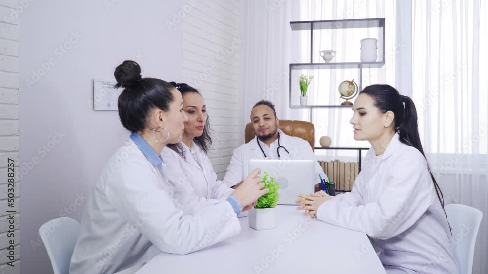 medical meeting, discussion of a medical preparation, multiethnic medical workers discuss medicine in ampoule medical meeting, discussion of a medical preparation, multiethnic medical workers discuss medicine in ampoule