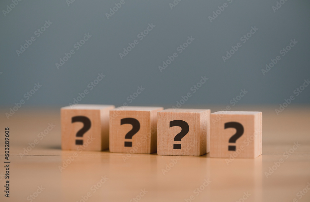 Question marks, Confused, Thinking, brainstorming or decision making, problem solving, finding answers, questions Mark word in wooden cube block on table background. FAQ Answer, Q&A. Question marks, Confused, Thinking, brainstorming or decision making, problem solving, finding answers, questions Mark word in wooden cube block on table background. FAQ Answer, Q&A.