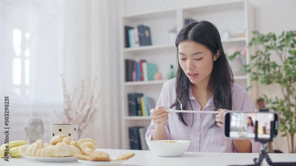 Korean woman blogger eating noodles for show, streaming video in social network Korean woman blogger eating noodles for show, streaming video in social network