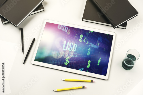 Top view of modern digital tablet monitor with creative USD symbols hologram. Banking and investing concept. 3D Rendering