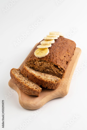 Fragrant banana bread on a light table on a wooden board