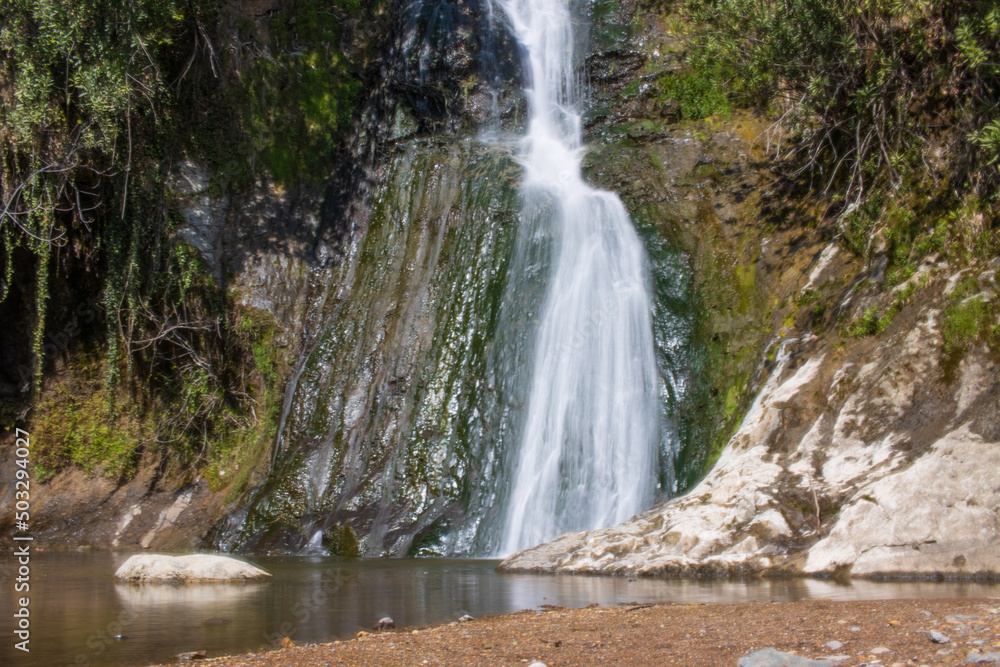 Fototapeta premium Beautiful and original panorama. Beautiful and majestic landscape and panorama of a mountain waterfall, a river, in textured and hard rocks and stones in the afternoon in the summer. High quality