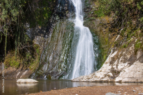 Beautiful and original panorama. Beautiful and majestic landscape and panorama of a mountain waterfall, a river, in textured and hard rocks and stones in the afternoon in the summer. High quality