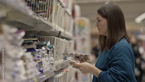 Young woman buys notebooks from the stationery department.