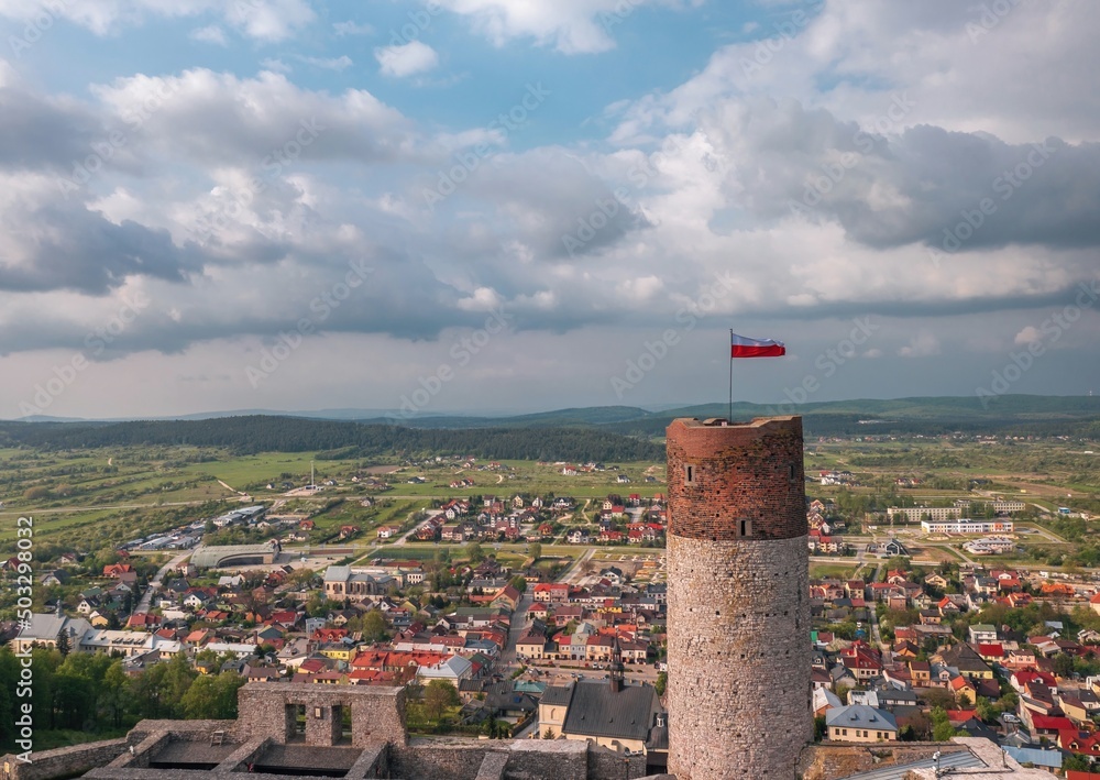 Aerial cityscape of Chęciny (Kielce, Poland) old town from the castle tower with a flag of Poland on top