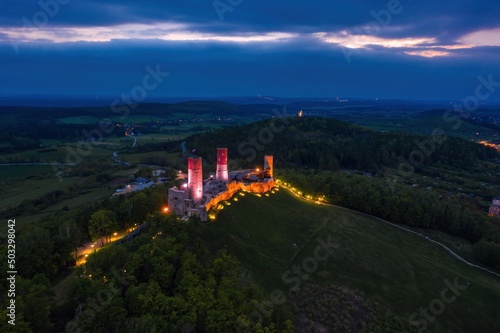 Obraz na płótnie Aerial drone night view over the colorful, illuminated Chęciny Castle (Kielce County, Świętokrzyskie Voivodeship) in Poland w salonie