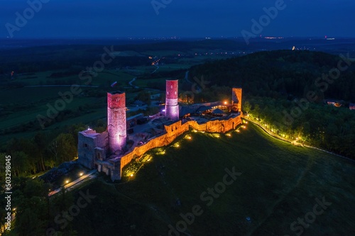 Obraz na płótnie Aerial drone night view over the colorful, illuminated Chęciny Castle (Kielce County, Świętokrzyskie Voivodeship) in Poland w salonie