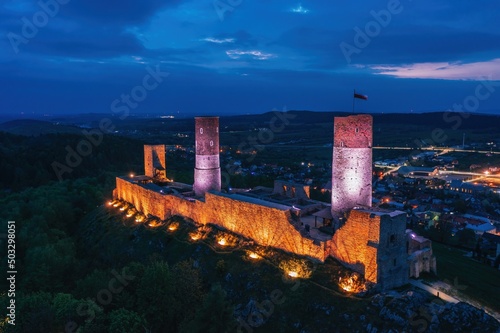 Obraz na płótnie Aerial drone night view over the colorful, illuminated Chęciny Castle (Kielce County, Świętokrzyskie Voivodeship) in Poland w salonie