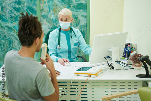 Young man during spirometry procedure in clinic photo