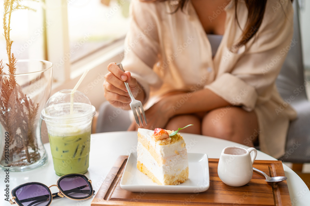 Young woman enjoying eating dessert and drinks in cafe while traveling Young woman enjoying eating dessert and drinks in cafe while traveling