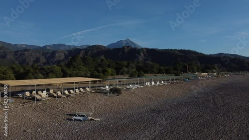 Morning deserted beach at dawn and lots of beach umbrellas. High quality 4k footage