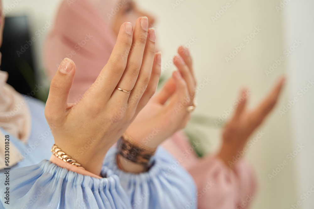 Cropped photot of Muslim female hands in religious prayer position Cropped photot of Muslim female hands in religious prayer position