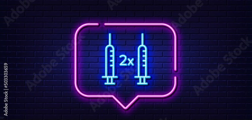 Neon light speech bubble. Coronavirus 2x vaccine line icon. Corona syringe sign. Covid jab symbol. Neon light background. Coronavirus vaccine glow line. Brick wall banner. Vector