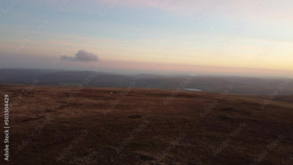 A 4K Aerial Drone Shot Rising Over Moor With a Lone Cloud. Lake, Fields and Crescent Moon A 4K Aerial Drone Shot Rising Over Moor With a Lone Cloud. Lake, Fields and Crescent Moon