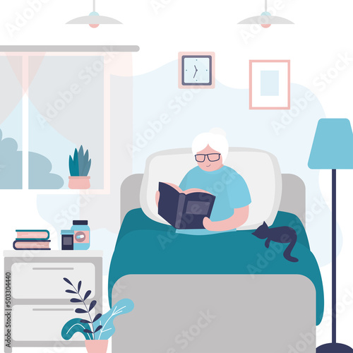 Grandmother read book in comfortable bed. Elderly woman reading book in morning. Grandma sits at home in bed with cat and enjoys hobby. Bedroom interior with furniture.