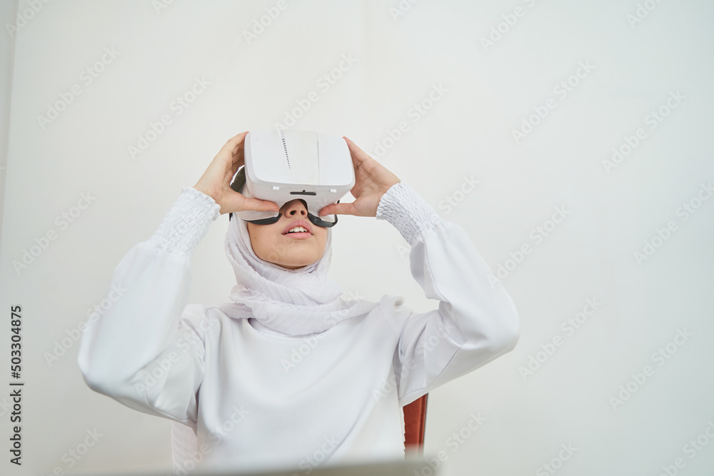 Muslim young woman wearing virtual reality glasses Muslim young woman wearing virtual reality glasses