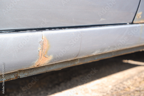 Corrosion, rust on the car body. car with Rust and Corrosion and paint bitumen. The concept of harm from reagents for the environment