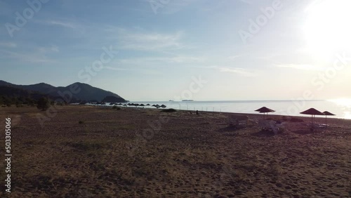 Morning deserted beach at dawn and lots of beach umbrellas. High quality 4k footage
