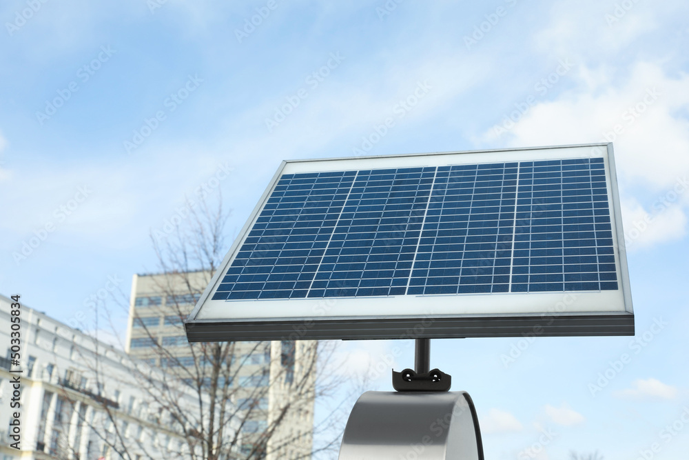 Small solar panel on city street. Alternative energy - obrazy, fototapety, plakaty 