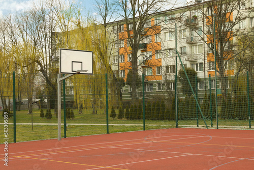 Basketball court at outdoor sports complex on sunny day photo