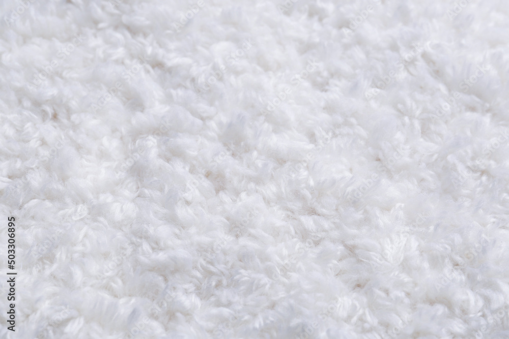 Soft white knitted fabric as background, closeup Soft white knitted fabric as background, closeup