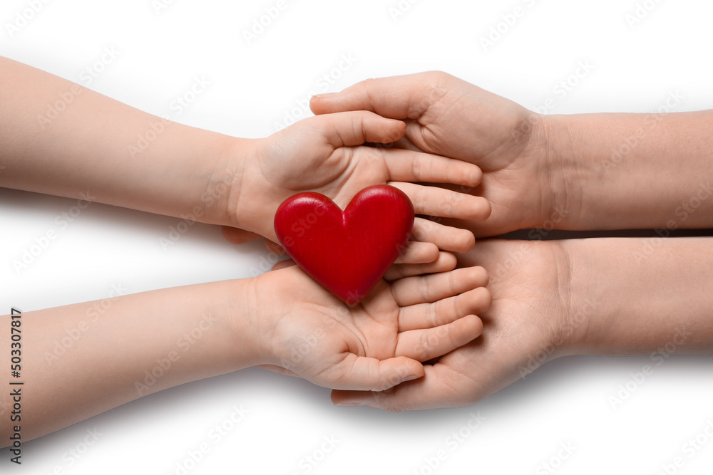 Fototapeta premium Woman and kid holding red heart in hands on white background, top view