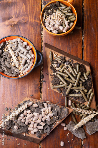 sunflower cake flakes with grass and bran granules and cereals for horses and other domestic animals. food concept. flat lay photo