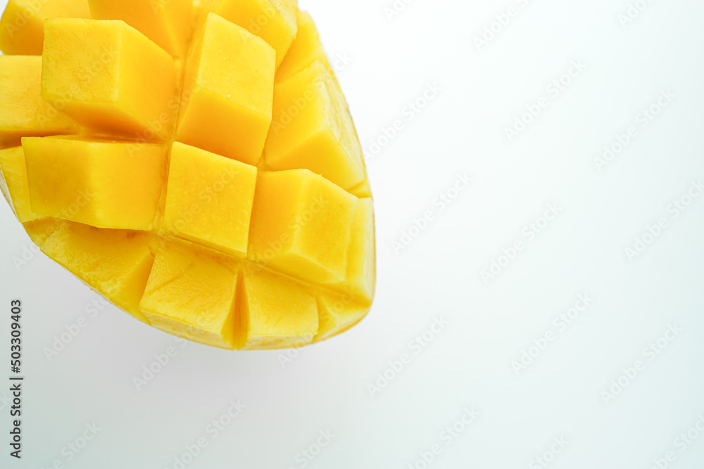 Fresh mango cut half and cube slice. Tropical fruit with isolated white background. Popular sweet dessert in Thailand.