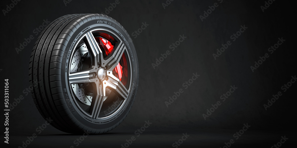 Car wheel. Disk with tyre and brakes on black background. - obrazy, fototapety, plakaty 